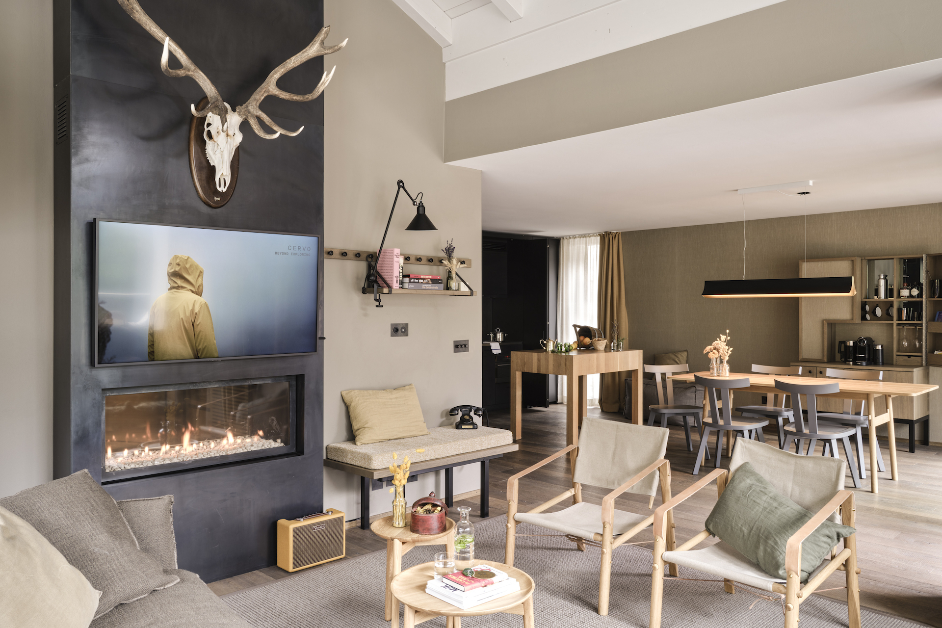 Living and dining area with fireplace in the Alpinist Roof Suite